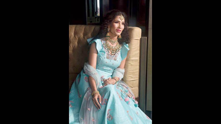 Actress Richa Sharma posed for a Diwali morning-to-evening look in the statement layered detachable choker necklace studded with polkis and emeralds, detailed with South Sea pearl drops. The statement neckpiece is complemented with a maangtika set in polki with pearl drops, a pair of emerald and polki jhumkas and polki bangles on both hands. A pastel blue outfit and make-up in shades of pink enhance the look.