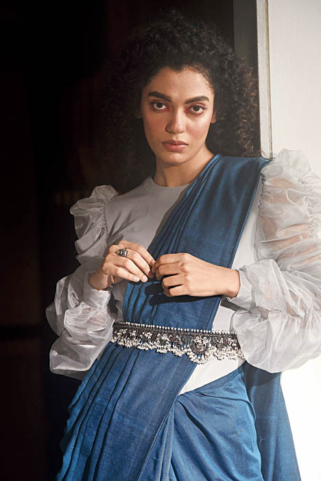 Contouring the empire line in a sari with a kamarbandh is in fashion. Use your heavy neckpieces to create the look. This silver Guttapusalu necklace from Abira is a classic design from Andhra Pradesh, fringed with small-sized pearl bunches around the edge, used for accessorising an ink blue handloom sari from Warssi Kolkata, paired with an organza blouse from Sixth Avenue Store.