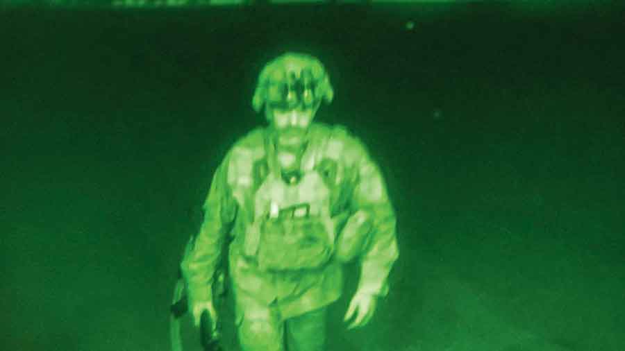 A night vision scope image  shows Maj. Gen. Chris Donahue, commander of the  US Army 82nd Airborne Division, XVIII Airborne Corps, boarding a C-17 cargo plane at the Hamid Karzai International Airport in Kabul on Monday. He was the last American service member to depart Afghanistan.  