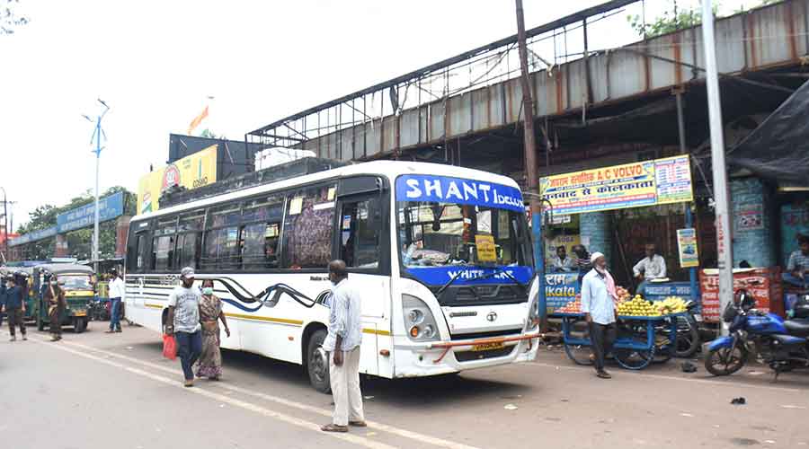 A bus picks up passengers at Dhanbad railway station bus stand in Dhanbad on Wednesday.