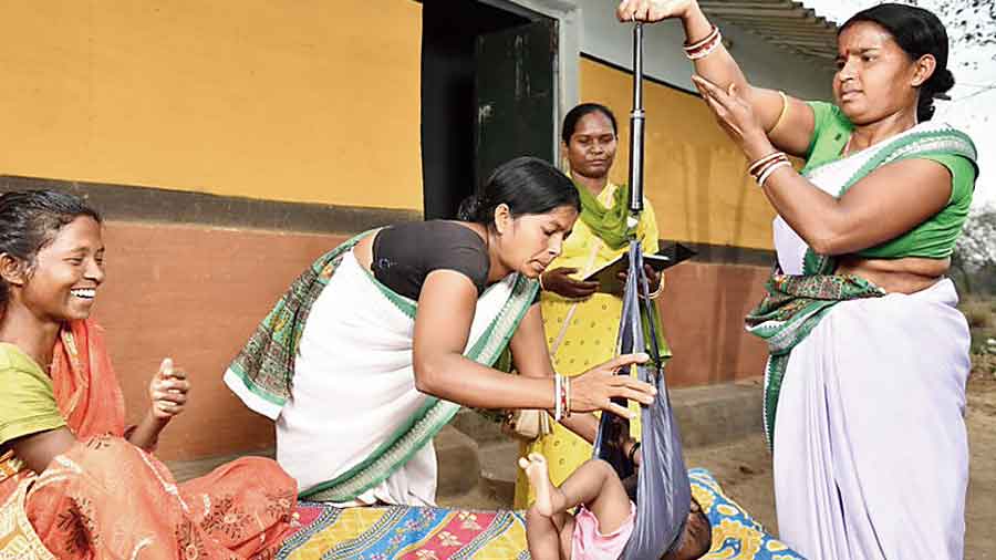 Sahiyas weigh a newborn in Seraikela-Kharsawan in Jharkhand. 