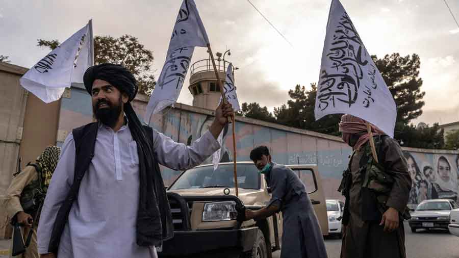 Taliban members outside the closed United States embassy in Kabul, Afghanistan, on Sunday, Aug. 22, 2021.