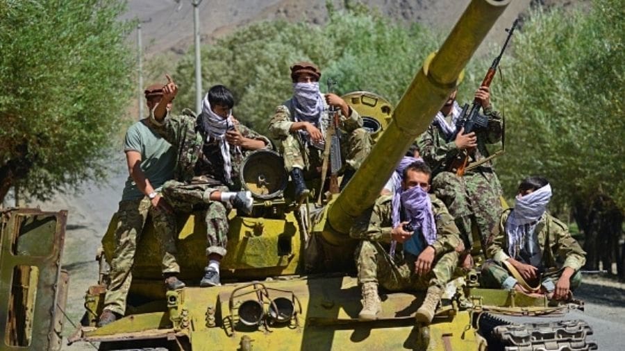 Afghan resistance movement and anti-Taliban uprising forces are pictured on a Soviet-era tank as they are deployed to patrol along a road in the Astana area of Bazarak in Panjshir province
