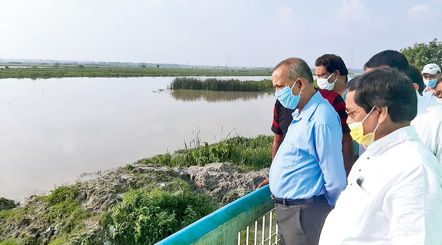 Chairperson of SMC board of administrators Gautam Deb (in blue shirt) at the Fulbari water treatment plant. 