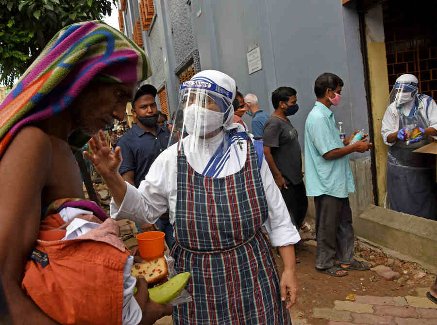 SERVING THOSE MOST IN NEED: A nun extends a helping hand to an elderly man on Sunday.