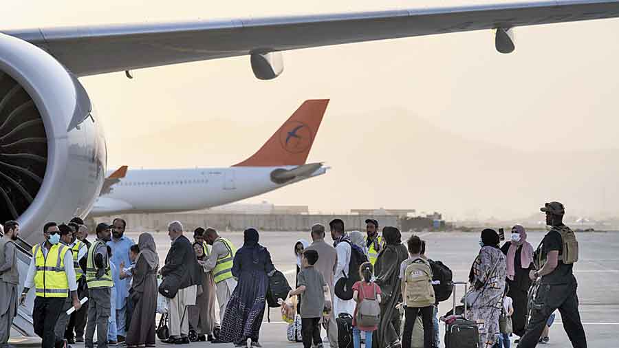 Foreigners board a Qatar Airways aircraft at Kabul airport on Thursday. 