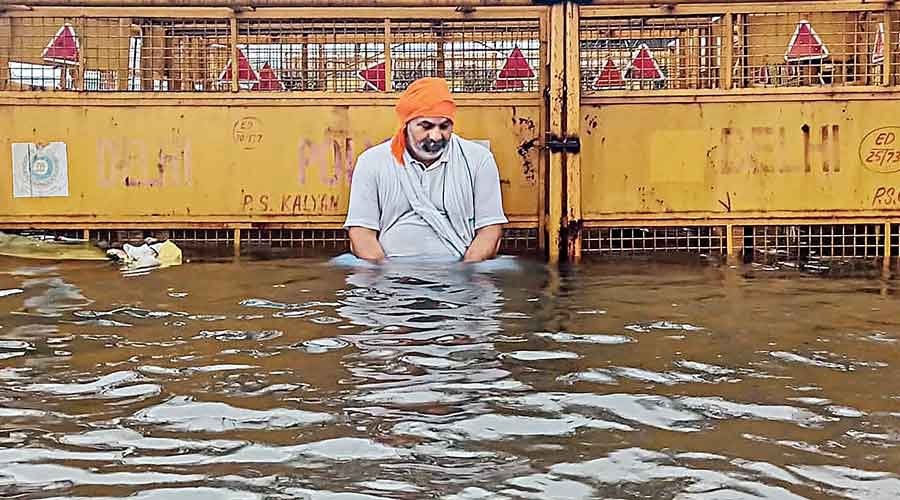 Farm leader Rakesh Tikait squats in water while staging a protest in Ghazipur, New Delhi,  on Saturday.