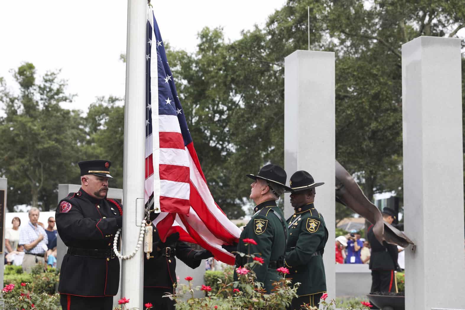 An honor guard raises the American flag to half staff at a memorial service on the 20th anniversary of the Sept. 11 attacks, at the Curlew Hills Memory Gardens in Palm Harbor.