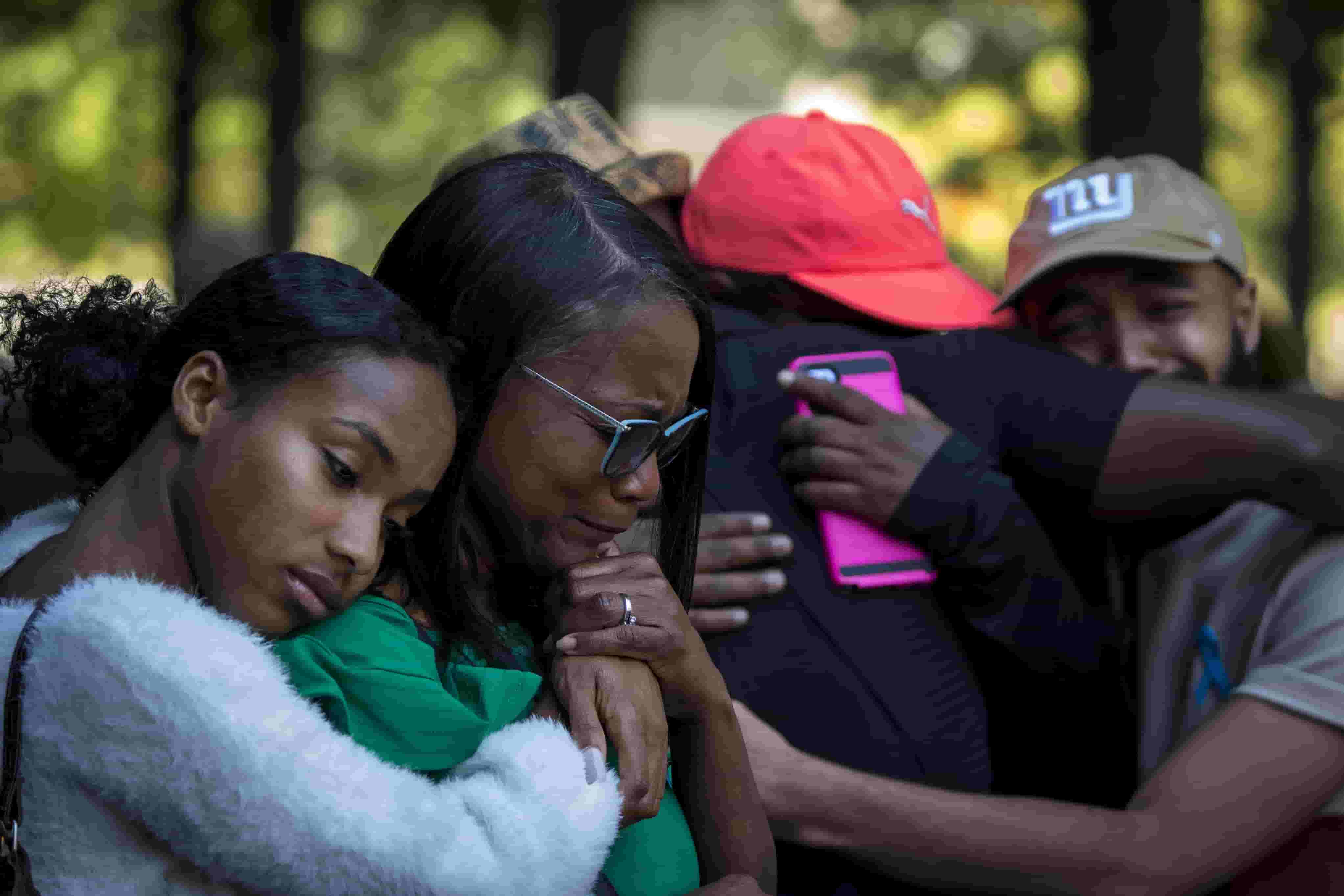 Sharon Booker and relatives grieve for her husband at a memorial service on the 20th anniversary of the 9/11 attacks, at the National September 11 Memorial and Museum in Manhattan, Saturday.