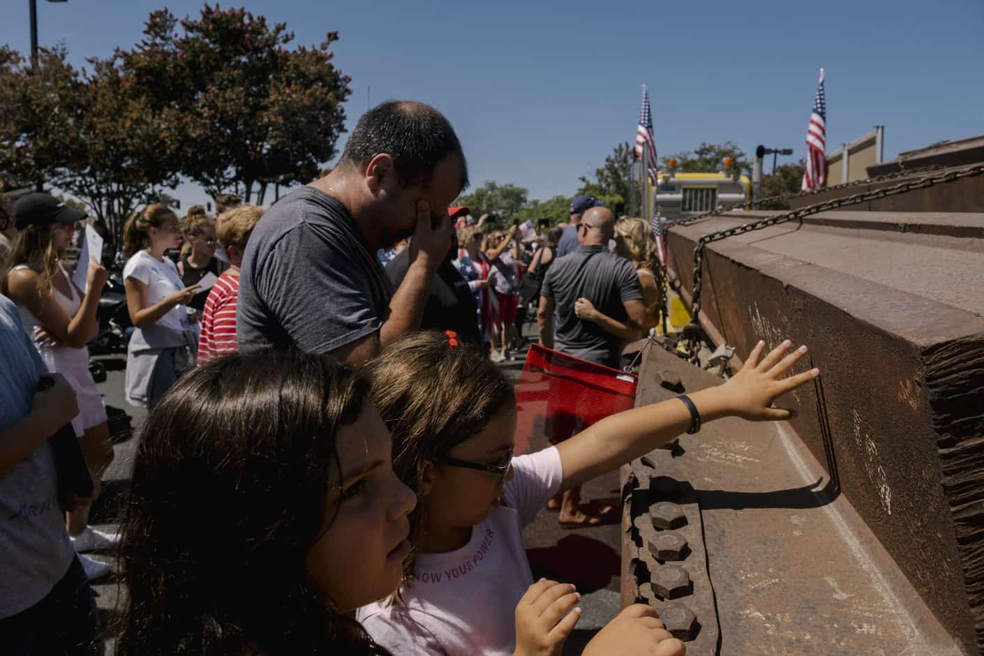 Attendees touch steel beams from the World Trade Center at a memorial event on the 20th anniversary of the Sept. 11 attacks, at the Richard Nixon Presidential Library in Yorba Linda, California.