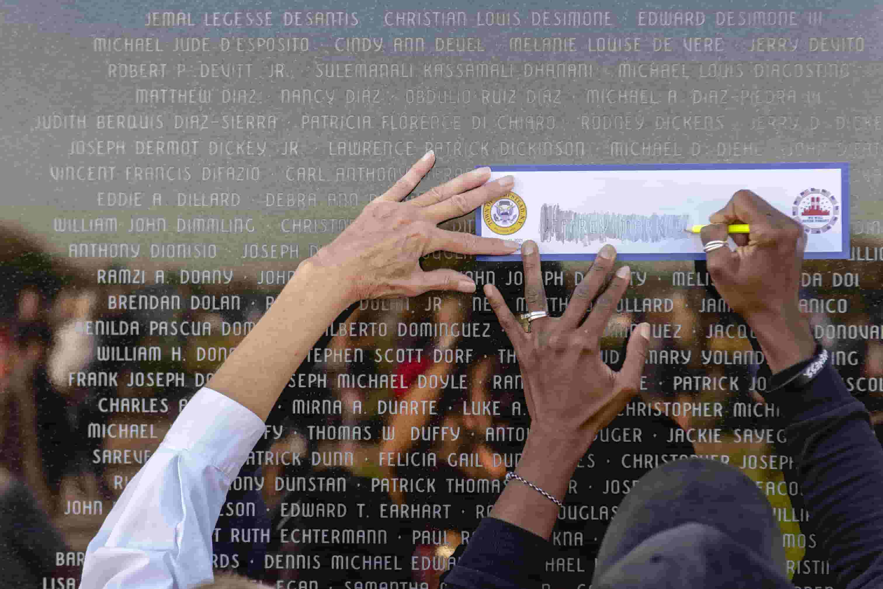 Mourners trace the name of a loved one at the 9/11 Sunrise Memorial in Lido Beach, New York, on the 20th anniversary of the attacks.