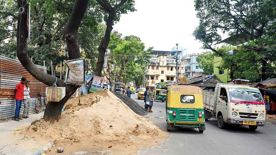 Construction materials kept on a pavement on Govinda Auddy Road in Chetla on Thursday. 