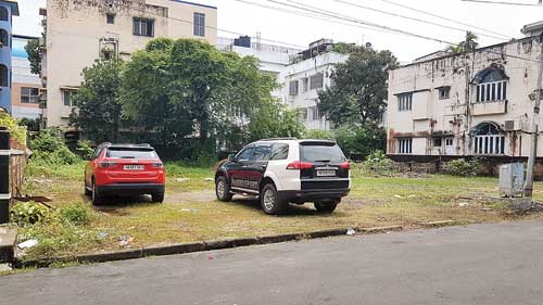 Cars parked in an empty plot in CL Block. 