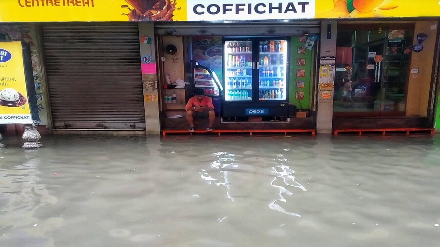 With no customer in sight, this shopkeeper had little to do in the waterlogged Amherst Street area of north Kolkata on Monday