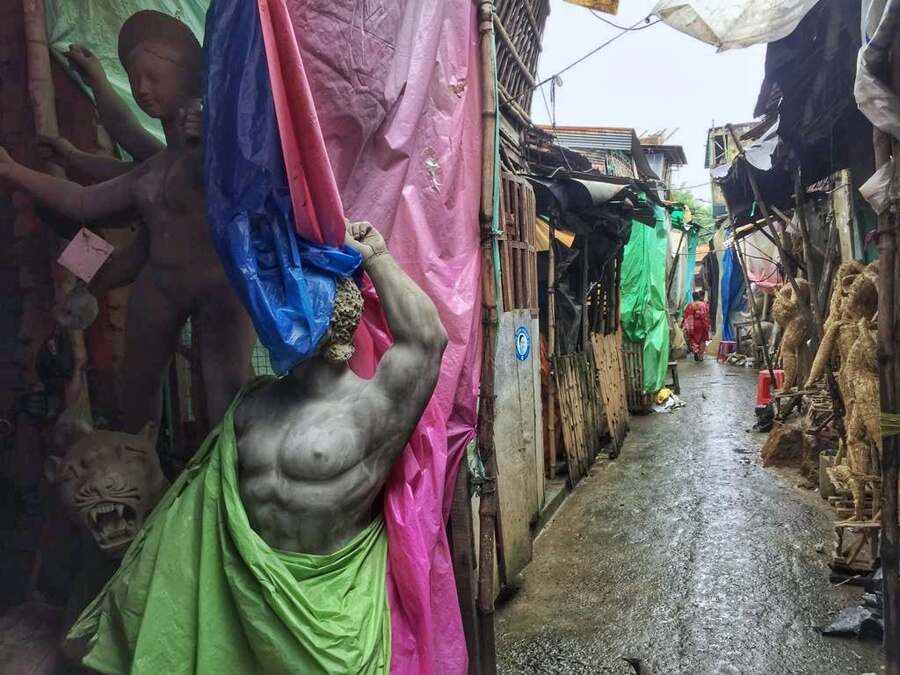 Idols get plastic protection from rain at Kumartuli in north Kolkata on Tuesday morning. Many areas in the city were waterlogged, some others were suffering intermittent power cuts and some areas in the city were without power on Tuesday morning