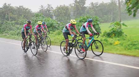 The team cycles through rain