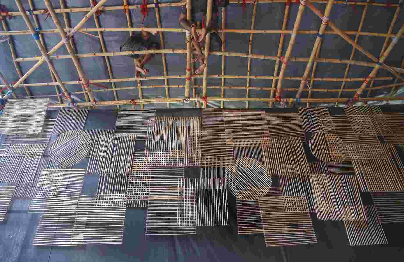 THAT TIME OF THE YEAR: Artisans weave the ceiling of a Durga Puja pandal from cane in Kolkata on Saturday, September 25. The one worry for the city this year is whether the later-than-usual rains will play spoilsport on Puja days