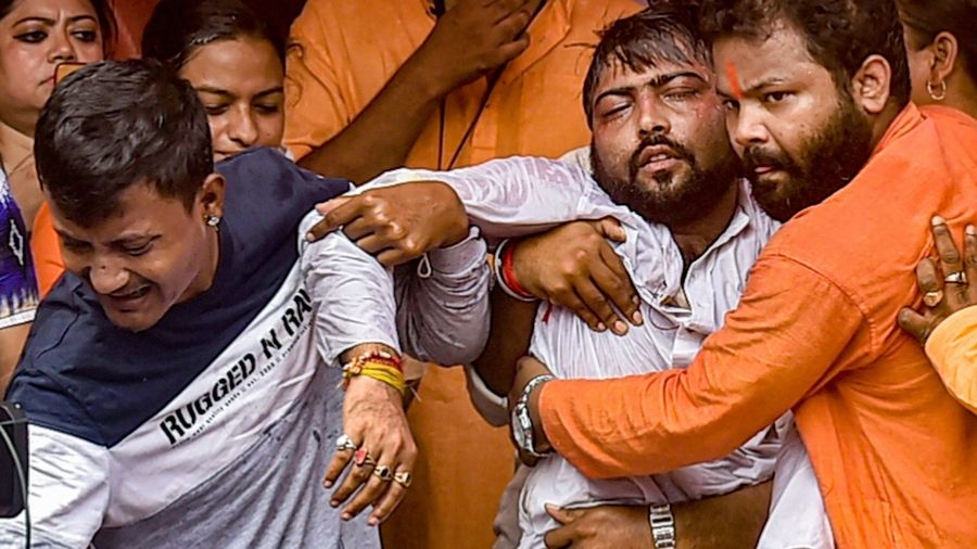An injured BJP worker being carried by members after being allegedly beaten by TMC workers, on Monday at Calcutta's Bhowanipore area.