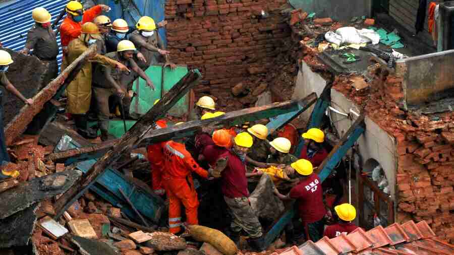 Jorabagan, 8am. Fire brigade and National Disaster Response Force personnel rescue members of two families trapped  after a dilapidated building collapsed on Ahiritola Lane in north Kolkata on Wednesday morning, when the city woke up to yet another day of dark clouds and rain. The cyclonic system that was tipped to trigger heavy showers arrived with howling winds on Tuesday evening, although the downpour did not really get heavy at night