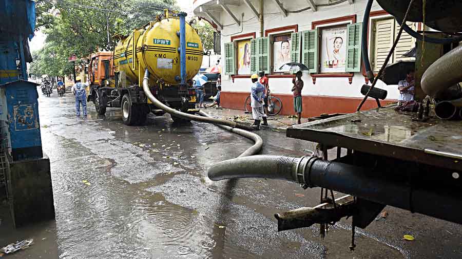 KMC machines drain out water from a road in Bhowanipore, near Elgin Road, on Wednesday.