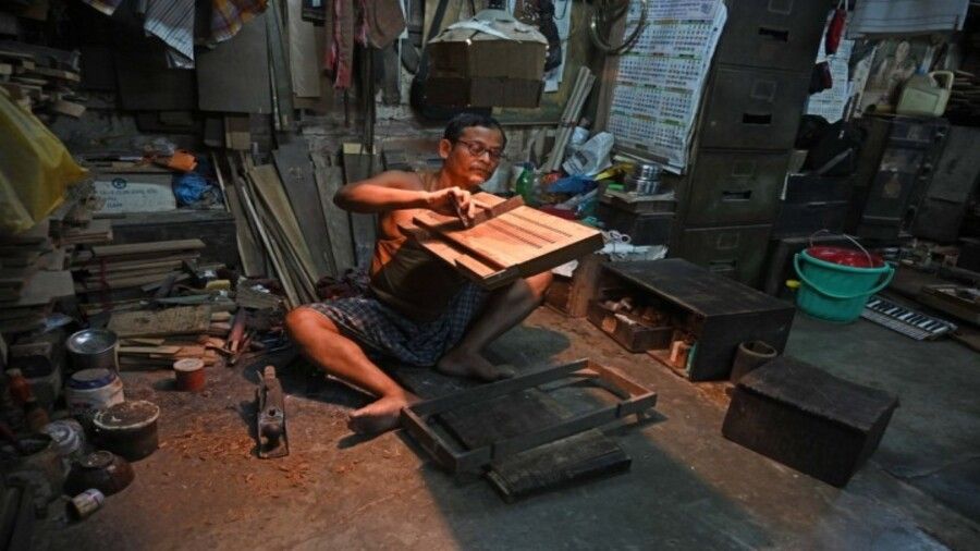 A worker crafts a harmonium. Debanjan Chakraborty, the third generation owner of The Melody, says that the shop has been a manufacturer of harmoniums since its inception and is its main source of income