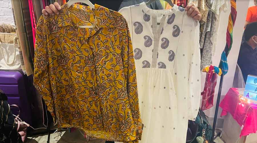A printed silk shirt upcycled from a sari and (right) a top made with a blue and white jamdani fabric 