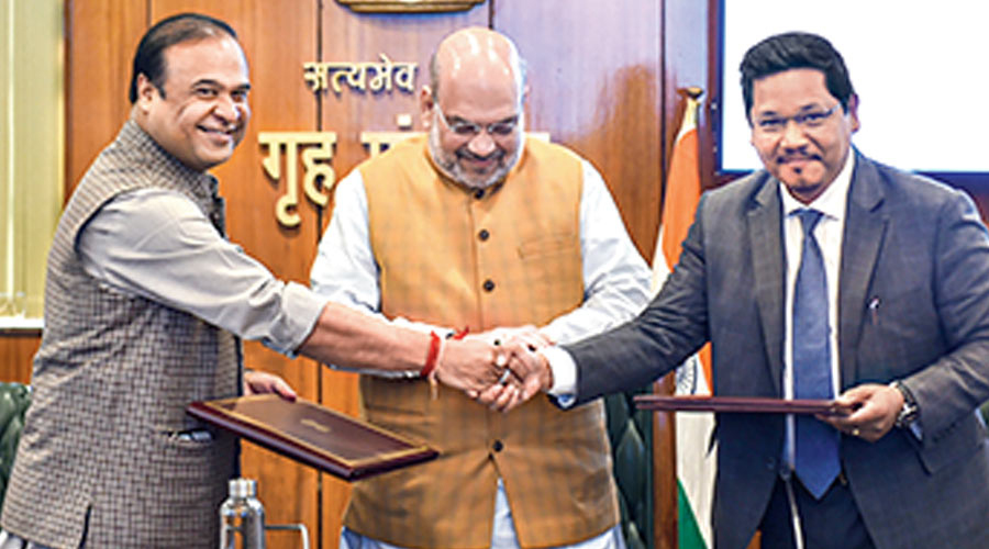 Assam Chief Minister Himanta Biswa Sarma(L) shakes hands with Meghalaya Chief Minister Conrad K Sangma after signing an agreement to resolve the 50-year-old pending boundary dispute between their states, in the presence of Union Home Minister Amit Shah, at North Block in New Delhi, Tuesday, March 29, 2022.