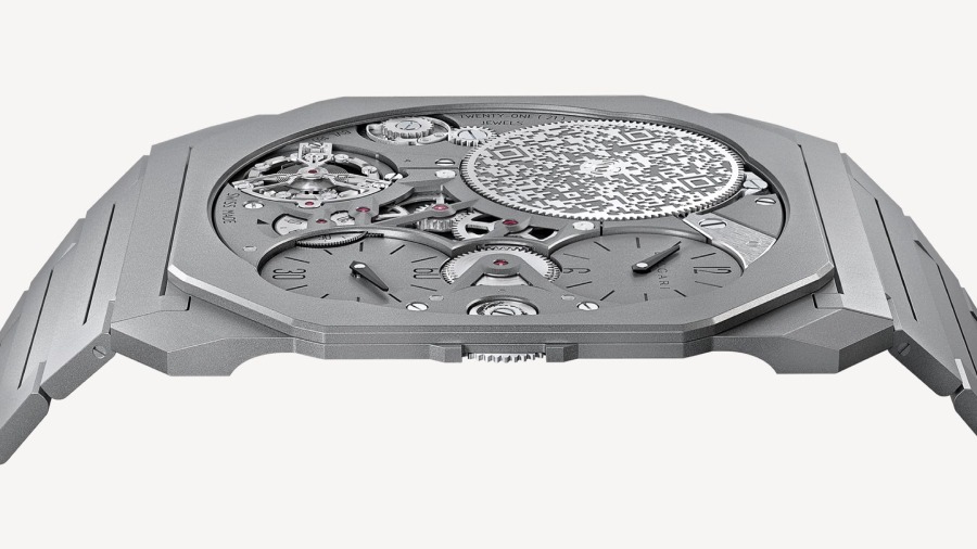 To keep the watch as flat as possible the makers had to think through most of the stacks in an usual watch, like hours and seconds hands and separate them and place the crown below the case, which is also the base plate for the components