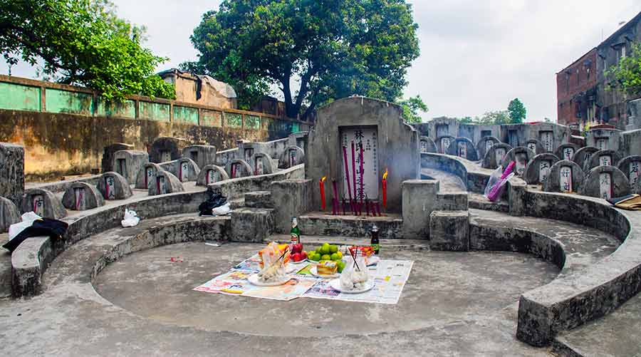 Food and drinks laid in front of a tomb at Choong Ye Thong Cemetery