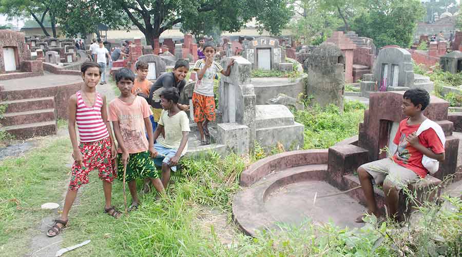 Local children provide a helping hand in carrying out the rituals