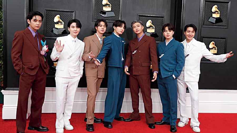 Suit game: What do you do when you see a group of good looking well-suited men? You take a screenshot and save the picture. BTS band members who attended the event looked dapper while rocking maroon, teal blue and white outfits.