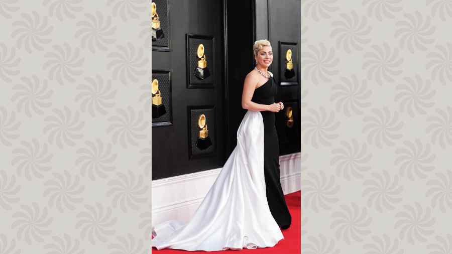Lady Gaga brought some classic Hollywood glam to the red carpet, as the singer-actor looked graceful in a floor-length black-and-white one-shoulder Armani Prive gown styled with a pin-curl updo and a stunning  statement neckpiece from Tiffany & Co.