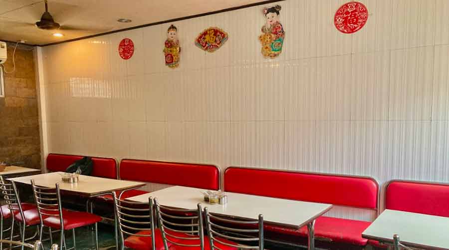 The spartan white tables and red chairs are part of Pao Chien’s charm