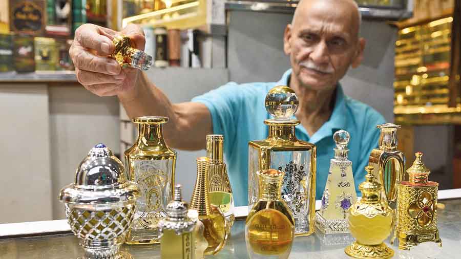 A man displays a variety of attar at his store in the neighbourhood.