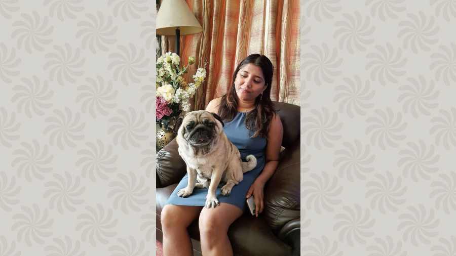 Pogo stares into the camera, perched on Amrita Roy’s lap. 