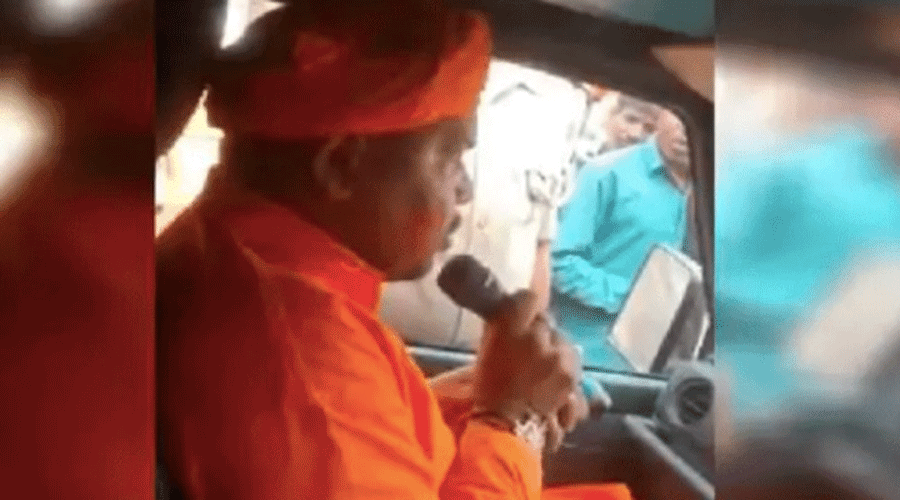 A video emerged on social media showing a clean shaven man in saffron robes speaking with a megaphone from inside an SUV.