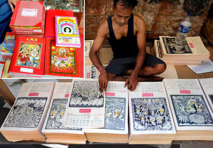   WELCOME, 1429: Bengali calendars on sale in the city and (inset) ledger books and Bengali almanacs at another stall on Thursday, April 7, ahead of the Bengali new year or Poila Baisakh on April 15 