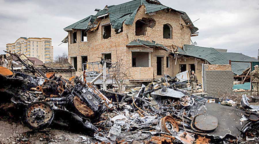 Ukrainian soldiers inspect a destroyed house, amid Russia's invasion of Ukraine, in Bucha, in Kyiv region.
