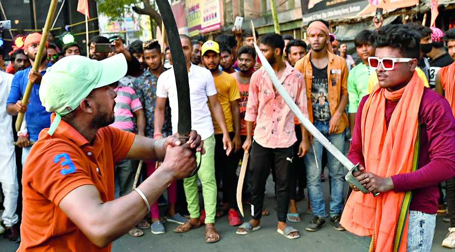 Participants brandish arms at a Ram Navami procession in Burdwan on Sunday.  