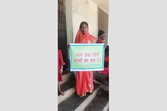 A woman holds a placard on right to clean air during the seminar at RIMS, Ranchi.