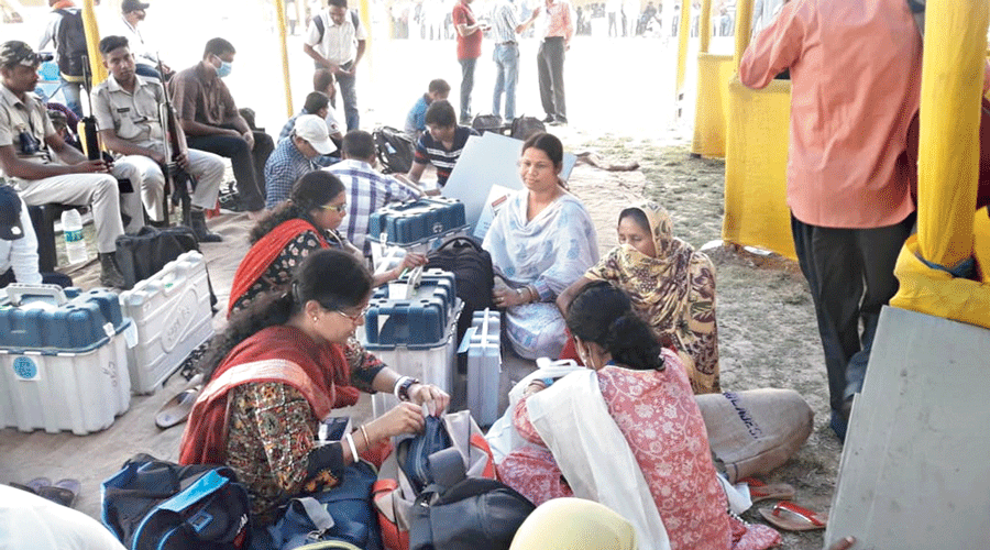 Election officials collect EVMs  and other voting material at a distribution centre in Asansol on Monday.