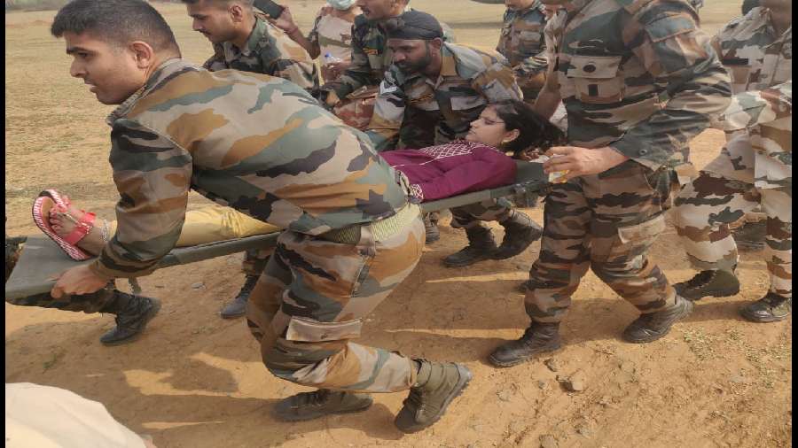 Indian Army make an injured person lie down after the ropeway mishap.