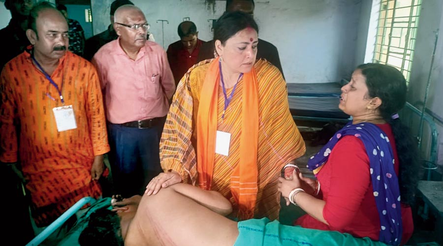 BJP candidate Agnimitra Paul meets the kin of an injured party worker in Jamuria on Tuesday. 