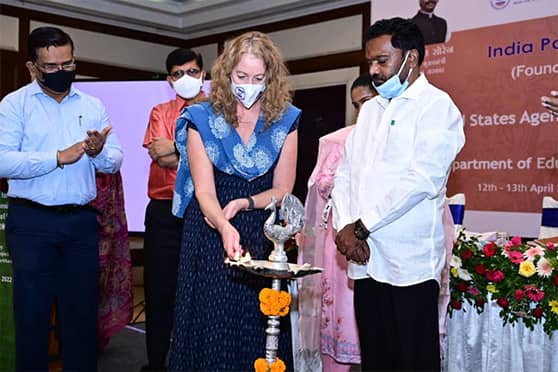 Karen Klimowski, deputy mission director, USAID India, lights a lamp as Jharkhand education minister Jagarnath Mahto (white shirt) looks on.