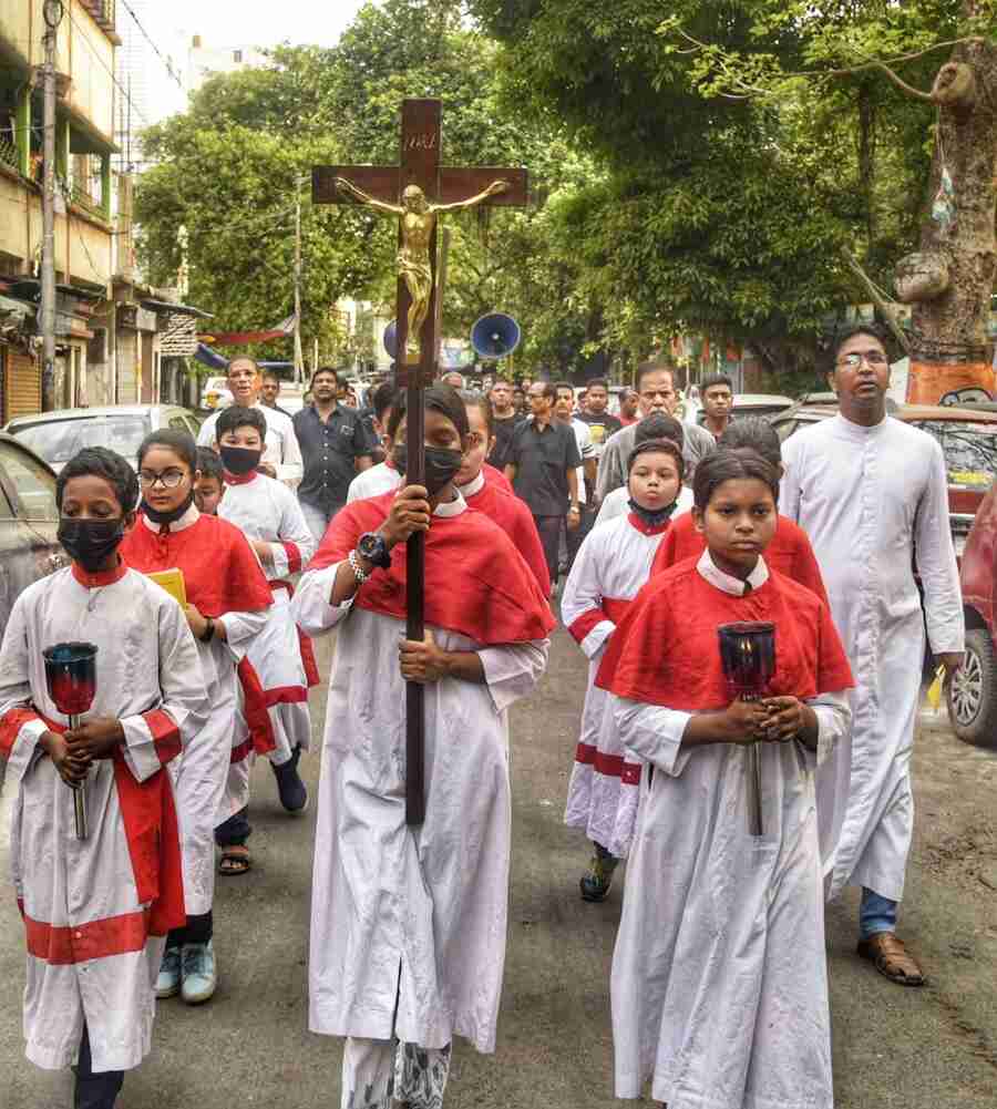 Members of a Christian congregation observe Good Friday with a procession in the city on Friday morning. Good  Friday commemorates Jesus Christ's crucifixion