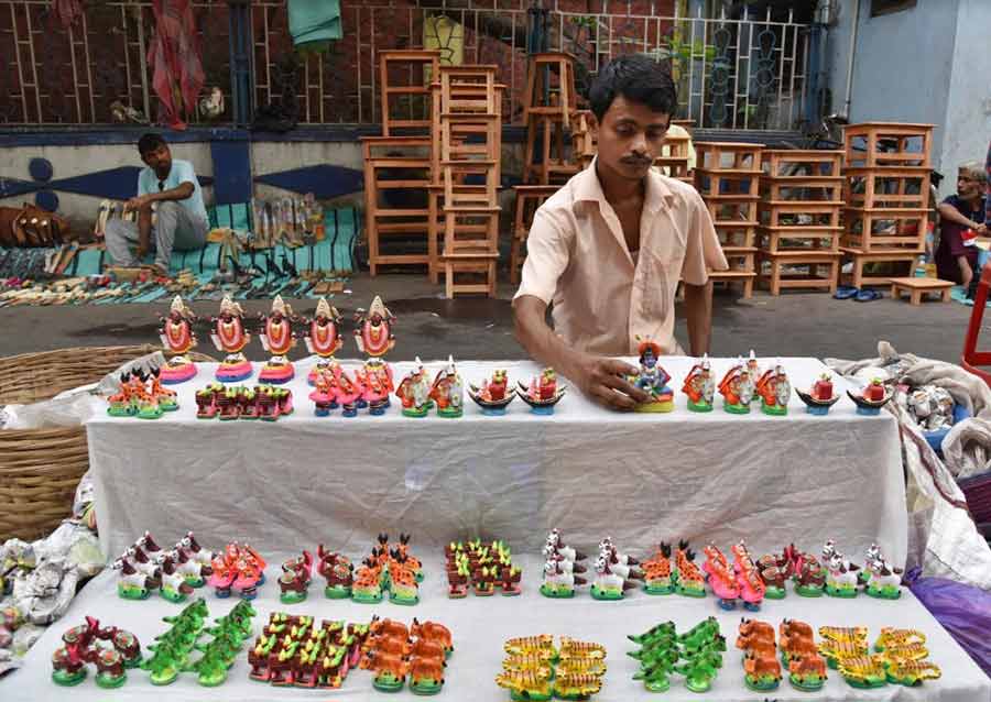 GLASS MENAGERIE: A man sells an array of figurines at a Gajan Mela on Beadon Street on the occasion of Charak on Thursday, April 14