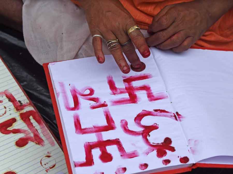 BLESSINGS: A Hindu priest draws religious symbols on a ledger book to mark the Bengali New Year near Kalighat temple on Friday, April 15 