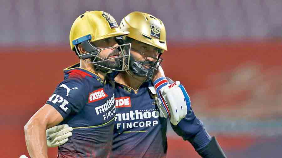 Virat Kohli (left) and Dinesh Karthik of Royal Challengers Bangalore during the IPL 2022 match against  Punjab Kings on March 27