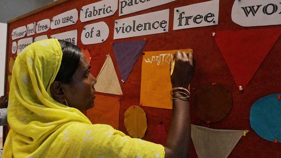 Women paint their dreams on fabric patches at the Indian Museum
