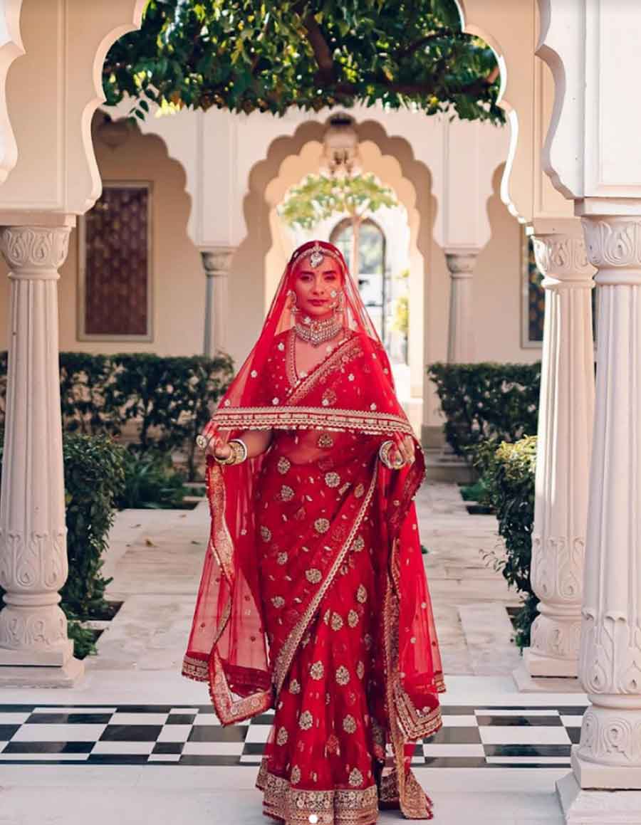 Patralekhaa: The actor’s all-red ensemble came with gold details. The sari was a tulle embroidered buti piece which she paired with an embroidered veil, inscribed with a Bengali verse that Sabyasachi penned himself for the bride and groom to mark their special day. Talk about a keepsake!